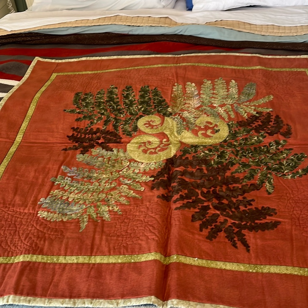 Beautiful terra cotta and green quilt wall hanging. Homemade.